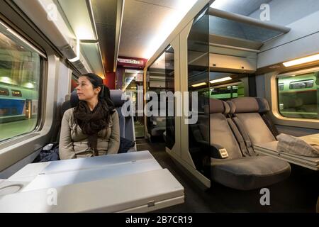 Young woman seating in first class on the TGV high-speed train, Gare Montparnasse, Paris, France, Europe