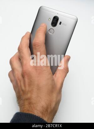 Rear view of a smartphone with dual camera lenses and a fingerprint scanner Stock Photo