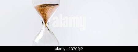 Sand flowing through an hourglass concept for time running out, panoramic mock-up Stock Photo