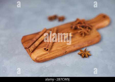 Indian seasonings on a wooden board. Anise stars and cinnamon stick Stock Photo