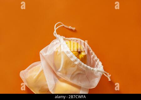 Zero waste concept. Eco bag with oranges. Bag Sewn from an old curtain. plastic is free, eco friendly concept. Reusable eco bag for shopping. Stock Photo