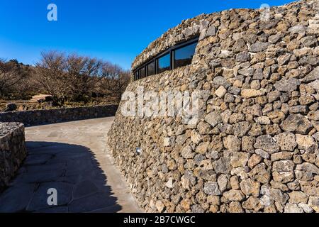 Modern Public Architecture. Curved Inclined Wall Made from Stone. The Rock Shed. Stock Photo