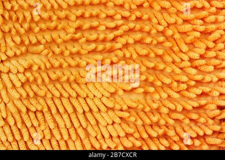 Texture of fabric with a large pile of orange color close-up. Stock Photo