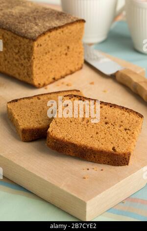 Traditional dutch breakfast cake and slices on a wooden cutting board Stock Photo