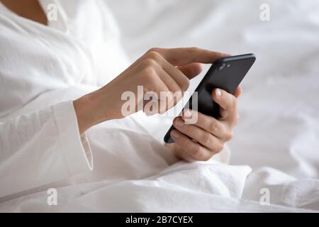 Close up focus on smartphone in female hands. Stock Photo