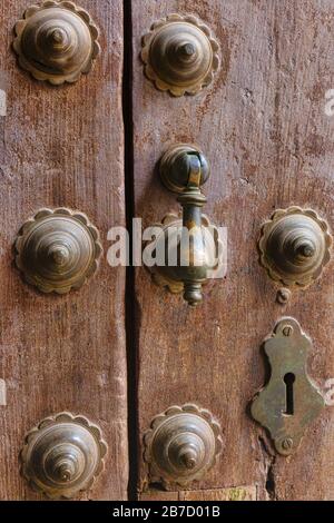 Keyhole, metal studs and door knocker on ancient wooden door. Cordoba, Cordoba Province, Andalusia, southern Spain.   The historic centre of Cordoba i Stock Photo