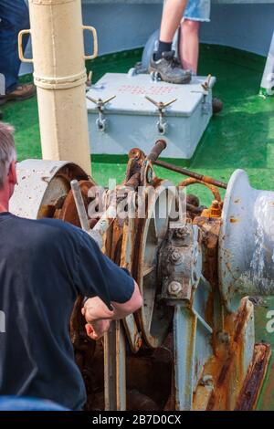 Sailors at the windlass on a ship Stock Photo