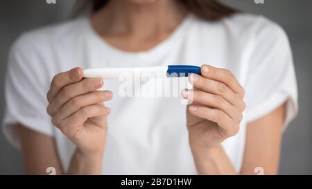 Close up pregnancy test in female hands of future mother. Stock Photo