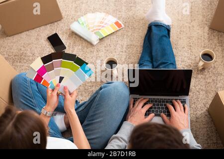 Young couple choosing color palette and furniture at home Stock Photo