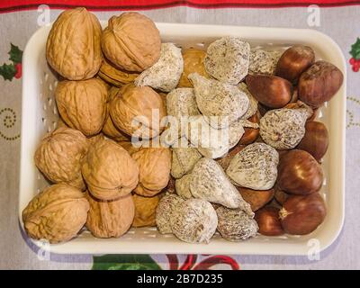 Basket with nuts, walnuts, chestnuts and dried figs Stock Photo