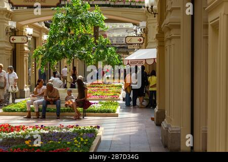 Tourists relaxing inside GUM shopping mall Stock Photo