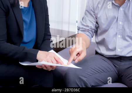 businessman and businesswoman talking about discussed document. Stock Photo