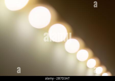 Blurry warm lights bokeh seen from a diagonal perspective. Stock Photo