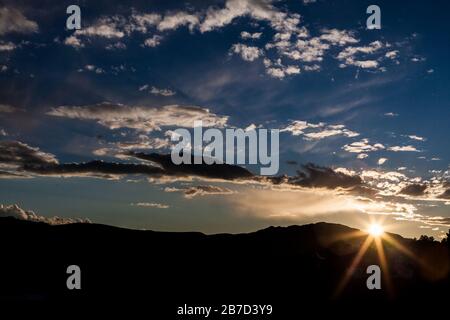 Sunset behind the mountains Stock Photo