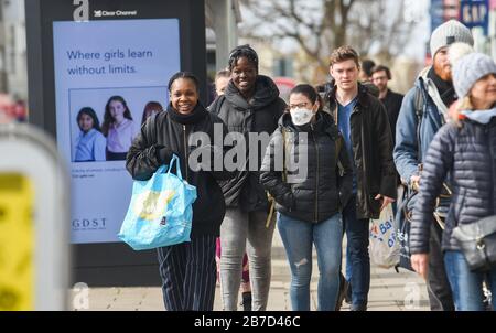 Brighton UK 15th March 2020 -  Shoppers , some wearing masks out in force in Brighton city centre today despite the Coronavirus COVID-19 pandemic. The British government has moved the country to the delay phase of tackling the virus whereas some countries in Europe including Italy , France and Spain have taken more severe measures  : Credit Simon Dack / Alamy Live News Stock Photo