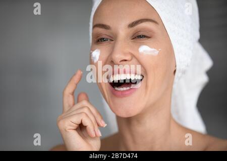 Happy lady grooming herself in bathroom, skincare routine. Stock Photo