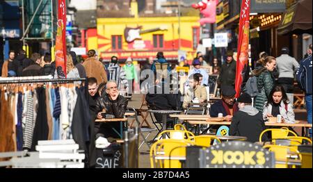 Brighton UK 15th March 2020 -  Shoppers out in force in Brighton city centre today despite the Coronavirus COVID-19 pandemic. The British government has moved the country to the delay phase of tackling the virus whereas some countries in Europe including Italy , France and Spain have taken more severe measures  : Credit Simon Dack / Alamy Live News Stock Photo