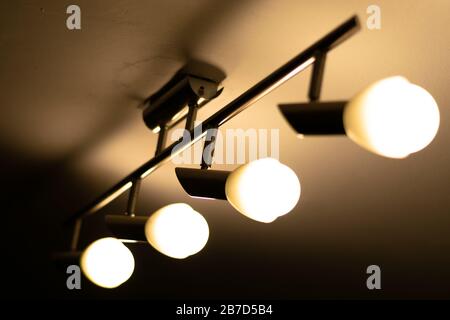 Some warm light bulbs mounted on a ceiling in a house - Electricity and illumination concept, Bucharest, Romania. Stock Photo