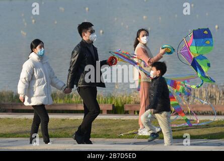 Fuyang City, China. 14th Mar, 2020. People wear protective masks amid Coronavirus threats at the Park in Fuyang City.There has been no increase on confirmed cases of covid-19 in many provinces of mainland China recently. The impact of the covid-19 epidemic on people's production and life in these areas is weakening and people are gradually starting to live a normal life. Credit: SOPA Images Limited/Alamy Live News Stock Photo