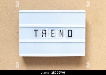 White lightbox with word trend on wood background Stock Photo