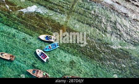 NGWE SAUNG/MYANMAR - MARCH 14, 2020 : Burmese fishermen bear caught fish in baskets on the beach Ngwe Saung Myanmar Stock Photo