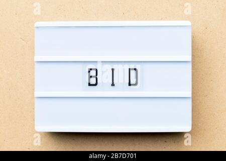 White lightbox with word bid on wood background Stock Photo