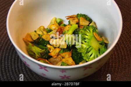 Grilled garlic with green broccoli. Vegetarian dish in a bowl. Stock Photo
