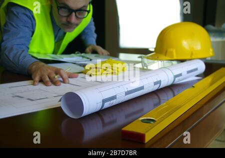 Construction manager, contractor, builder or engineer in workplace. Working man over building sketch. Architecture, engineering and industry concept. Stock Photo