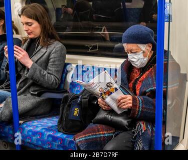 London, UK. 15th Mar, 2020. An elderly lady brave the tub and Coronavirus, wearing an inefectual mask. Credit: Guy Bell/Alamy Live News Stock Photo