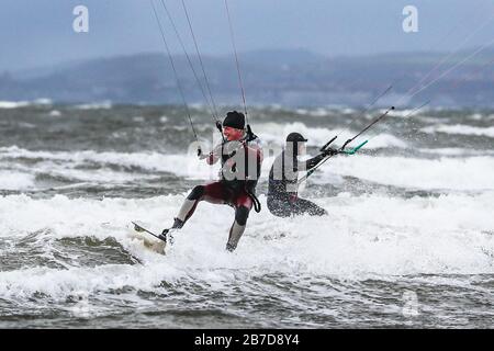 Troon, UK. 15th Mar, 2020. Not all sports are restricted by the fear of spreading Covid-19 and water sports enthusiasts take advantage of the strong winds and high waves on the Firth of Clyde off the Ayrshire coast. Credit: Findlay/Alamy Live News Stock Photo