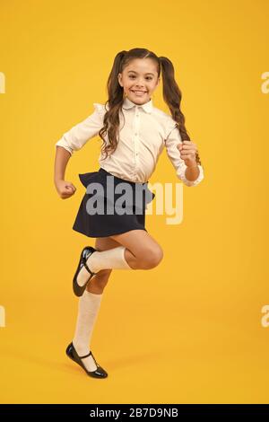 Keep going. Active child in motion. Freedom concept. Knowledge determined success. Active kid. Girl on way knowledge. Knowledge day. Back to school. Kid cheerful schoolgirl running. Pupil want study. Stock Photo