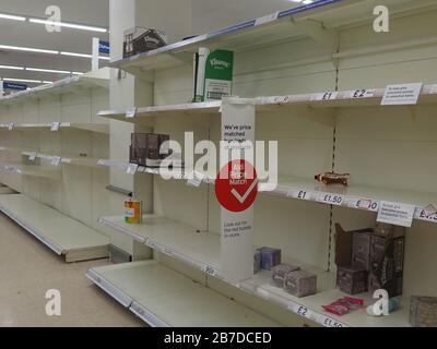 Sheerness, Kent, UK. 15th Mar, 2020. Vast empty shelves in Tesco Sheerness - almost the entire aisle where the toilet rolls are usually located - due to coronavirus panic buying. Credit: James Bell/Alamy Live News Stock Photo