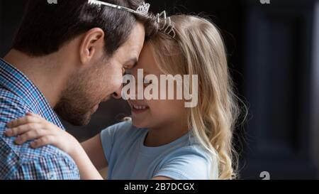 Happy dad and little daughter play funny game together Stock Photo