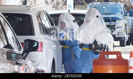 New Rochelle, USA. 15th Mar, 2020. Medical professionals take oral swabs to test for the COVID-19, coronavirus at a newly opened drive through testing facility March 14, 2020 in New Rochelle, New York. Credit: Sean Madden/Planetpix/Alamy Live News Credit: Planetpix/Alamy Live News Stock Photo