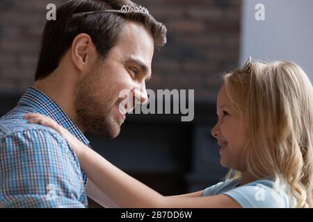 Happy young dad and little girl play girlish game Stock Photo