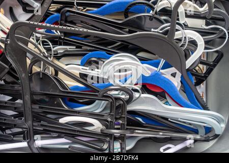 A messy, untidy pile of plastic coat hangers Stock Photo