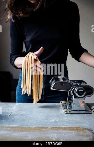 Woman Making Fresh Pasta in a kitchen Stock Photo