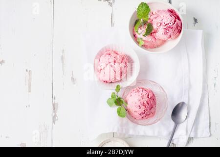 Top view image of pink ice cream balls with raspberries and fresh mint Stock Photo