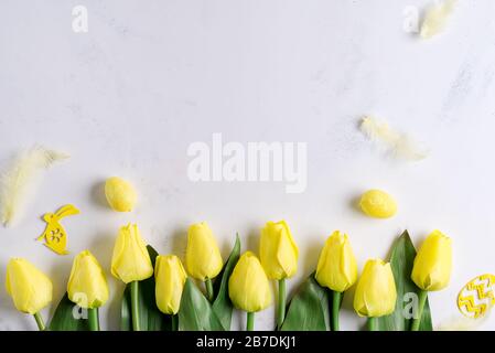 Flat Lay of Easter Eggs with tulips on stone marble background. Easter background or easter concept. Stock Photo