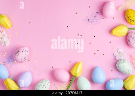 Easter Eggs with tulips on pink stars background. Easter background or easter concept. Stock Photo