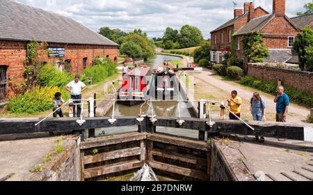 Braunston Lock with narrowboats descending on the Grand Union Canal, Warwickshire, Braunston,  England, UK, Britain Stock Photo
