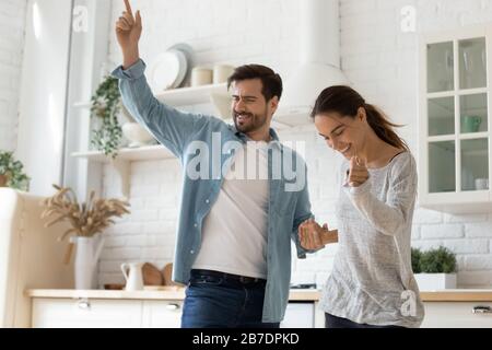 Happy loving couple dancing in modern kitchen together Stock Photo