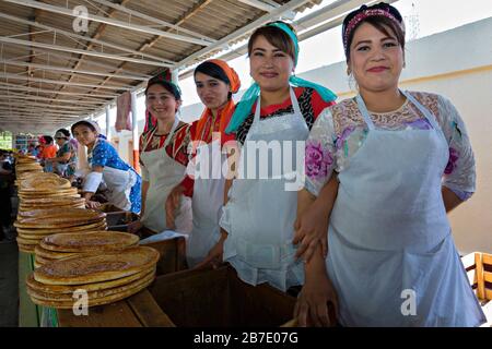 Uzbek girls selling local bread, in Fergana Valley, Uzbekistan. Stock Photo
