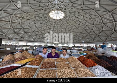 Three vendors in the Chorsu Bazaar, in Tashkent, Uzbekistan. Stock Photo
