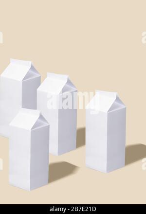 White milk cans are standing on the yellow background. Stock Photo