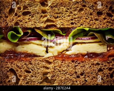 A ploughmans cheese sandwich on bown bread, close up Stock Photo