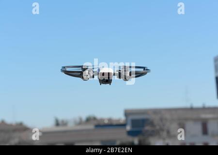 remote aerial quadcopter drone, with hight resolution camera, flying in the countryside, which makes a survey of the territory, Italy Stock Photo