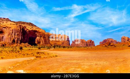 Massive Red Sandstone Buttes in Monument Valley, a Navajo Tribal Park on the border of Utah and Arizona, United States Stock Photo