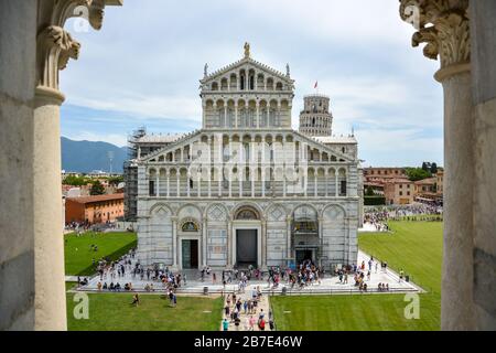PISA, ITALY - August 14, 2019: The cathedral of Pisa near the leaning tower of Pisa with lots of tourists on a sunny day