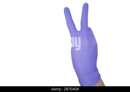 Hand of surgeon with a blue medical glove showing victory sign, isolated on a white background with space for text Stock Photo